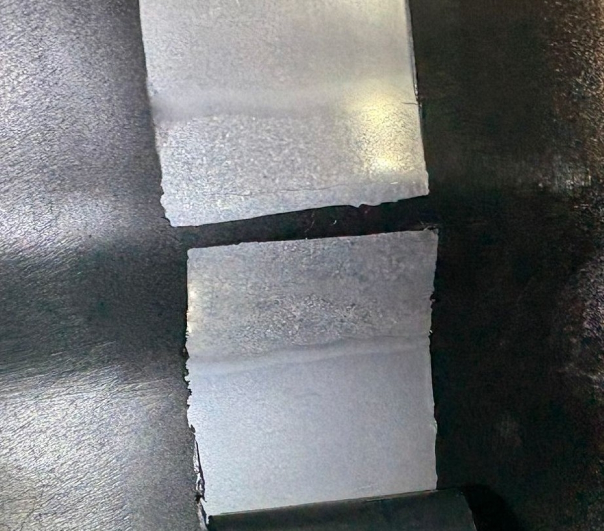 Metallographic Replication: Weld and HAZ Analysis Macro-etched surface of a pipe weld showing the distinct metallurgical zones including the weld metal, heat-affected zone (HAZ), and parent