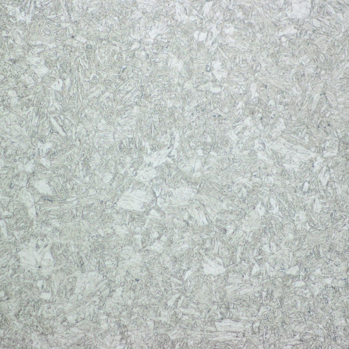 Photomicrograph of a quenched, martensitic microstructure in a structural steel, indicating specific thermal processing.