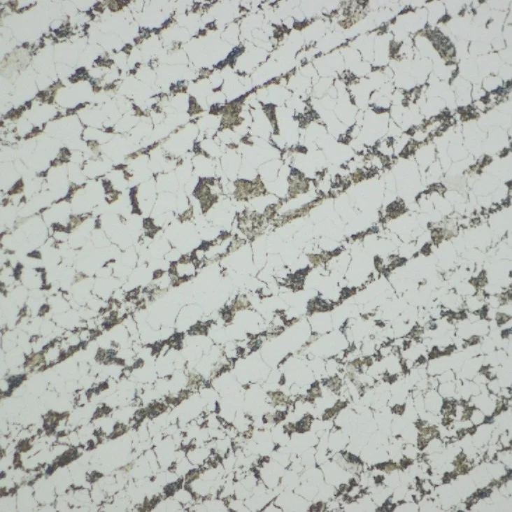 Photomicrograph showing a ferrite and banded pearlite microstructure that is indicative of rolled or forged structural steel
